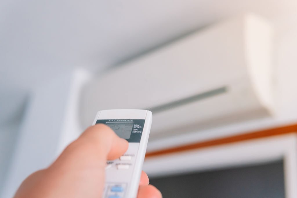 Person using an indoor hot air pump in a house. Technology concept. Person using an indoor hot air pump in a house. Technology concept.